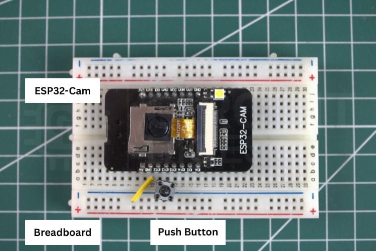 Hardware connection of ESP32-CAM object detection project on a breadboard with push button and USB cable