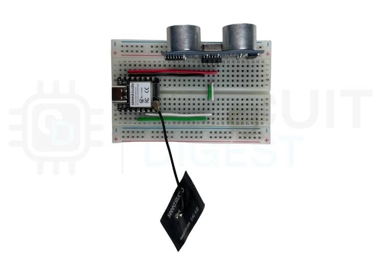 Physical hardware setup showing Seeed Studio XIAO ESP32 connected to HC-SR04 sensor on breadboard