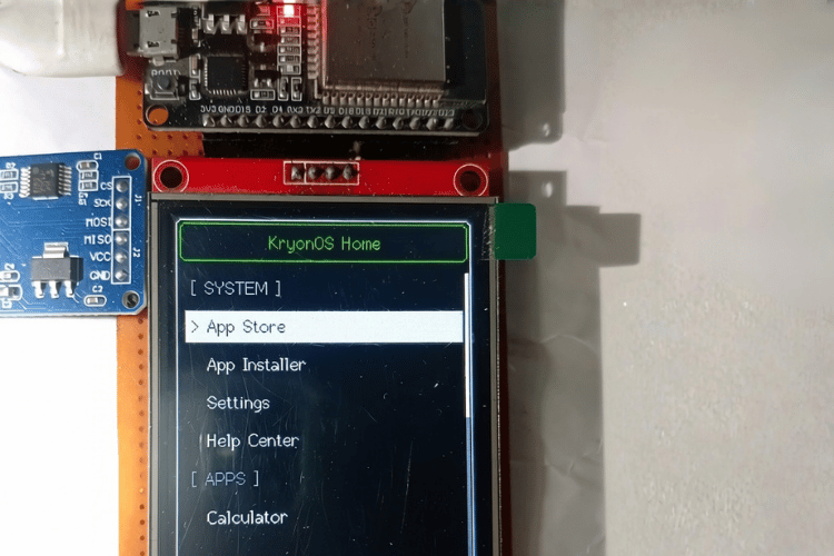 Hand Interacting With ESP32 Running KryonOS Interface