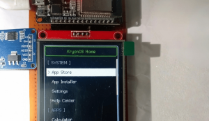 Hand Interacting With ESP32 Running KryonOS Interface